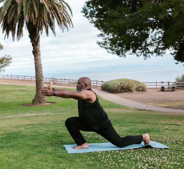 Person stretching gently outdoors, embodying a sense of peace and well-being.